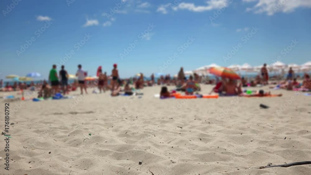 Crowded sand beach scene with unrecognizable tourist people Crowded sand beach scene with unrecognizable tourist people