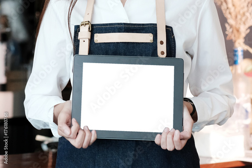 Young asian woman holding blank screen tablet at cafe background, food and drink concept