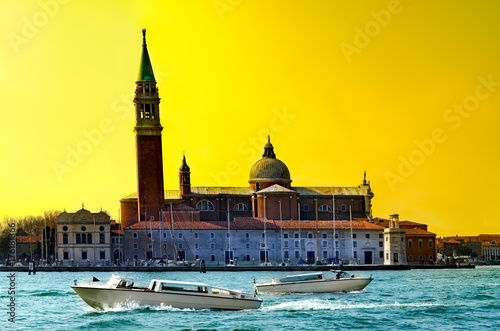 Sunset view of San Giorgio island with boats on Canal Grande, Venice, Italy