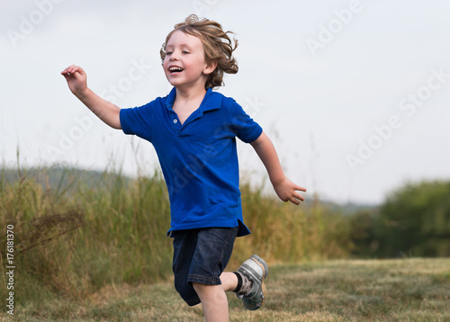 Boy runs in Vermont field path