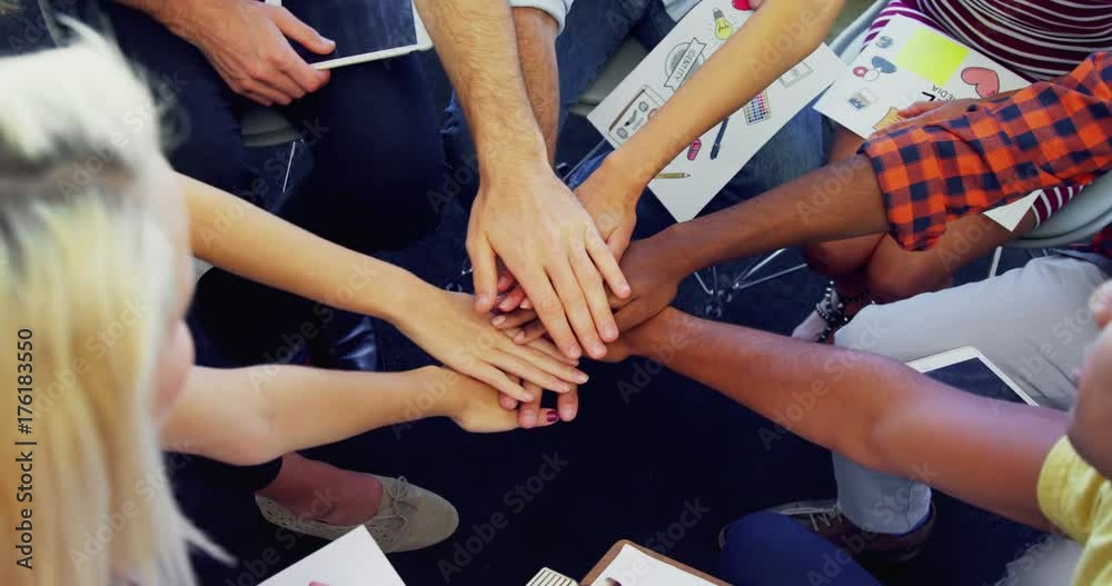 Group of executives forming hand stack Group of executives forming hand stack