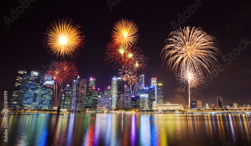 firework over central business district building of Singapore city at night