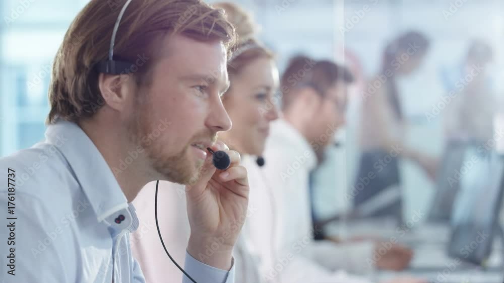  Friendly customer service operators taking calls in busy call center