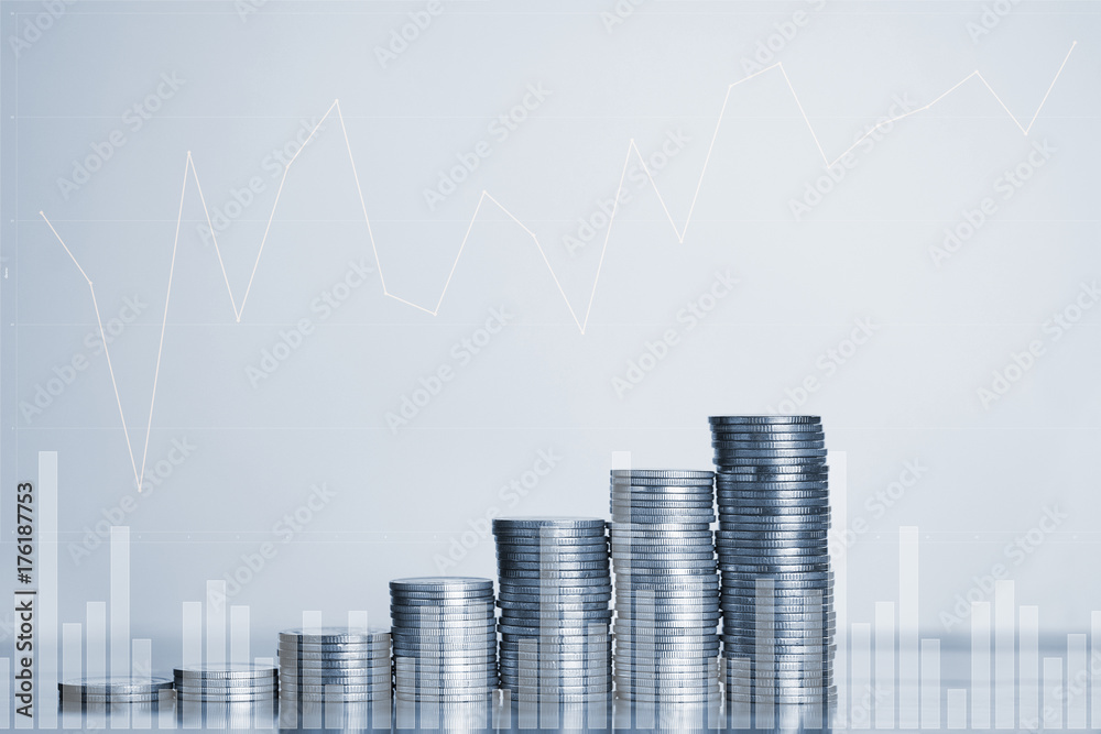 Double exposure Stacks of coins on working table with financial graph chart, finance and business concept,