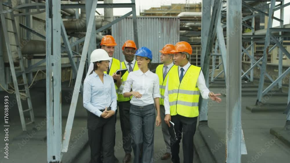 Portrait smiling multiracial team of engineers at industrial site Portrait smiling multiracial team of engineers at industrial site