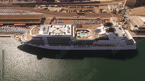 Huge large mega ULCV container ship sails on open water fully loaded with containers and cargo - aerial 4k view