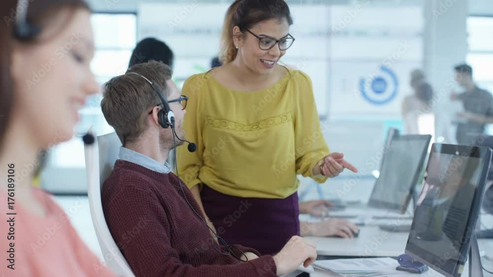 Cheerful customer service team talking to each other & assisting customers Cheerful customer service team talking to each other & assisting customers