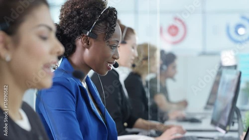  Friendly customer service operators taking calls in busy call center