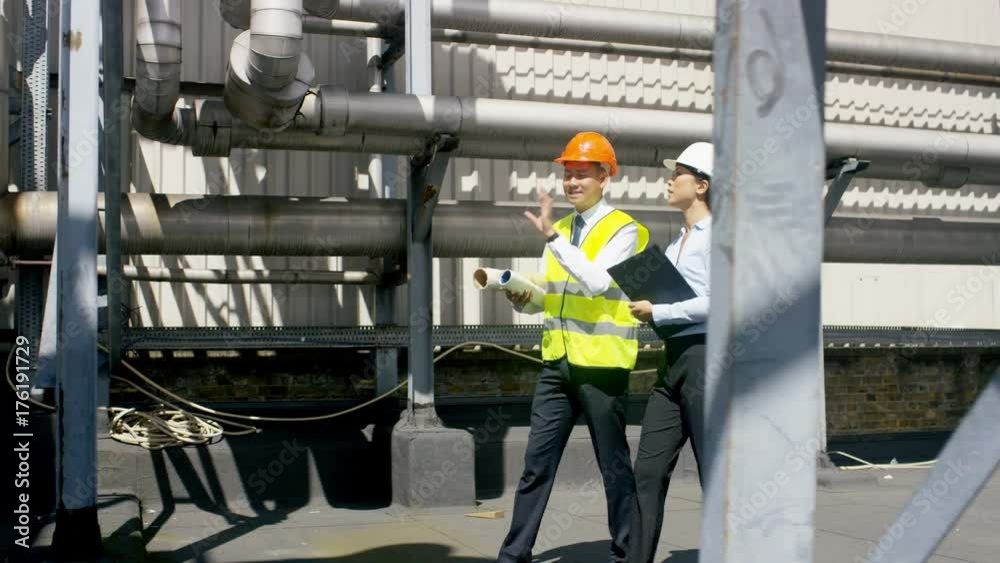Engineers carrying out an inspection at urban industrial site Engineers carrying out an inspection at urban industrial site