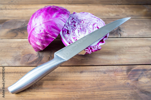 red cabbage on a wooden table with knife