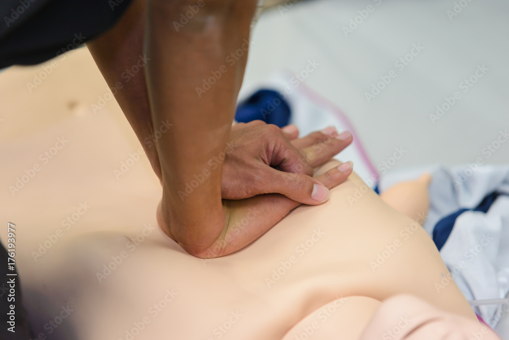 Fototapeta premium CPR First Aid Training with CPR dummy in the class