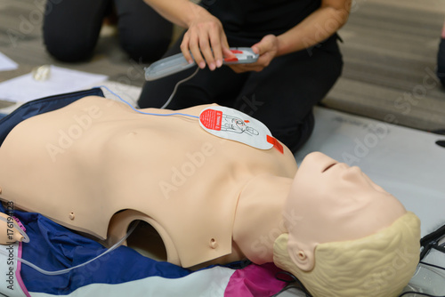 Obraz na płótnie CPR First Aid Training with CPR dummy in the class