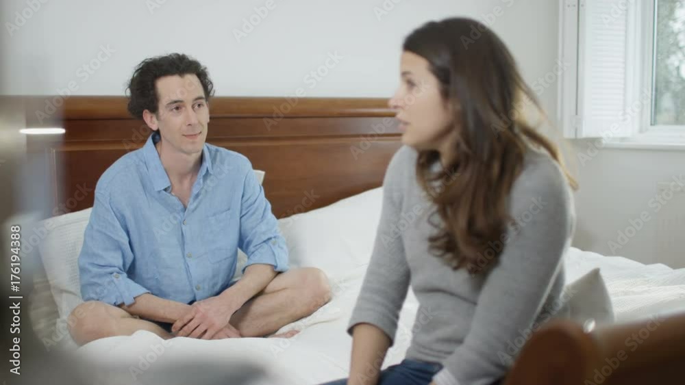 Couple with relationship problems having emotional conversation in bedroom Couple with relationship problems having emotional conversation in bedroom