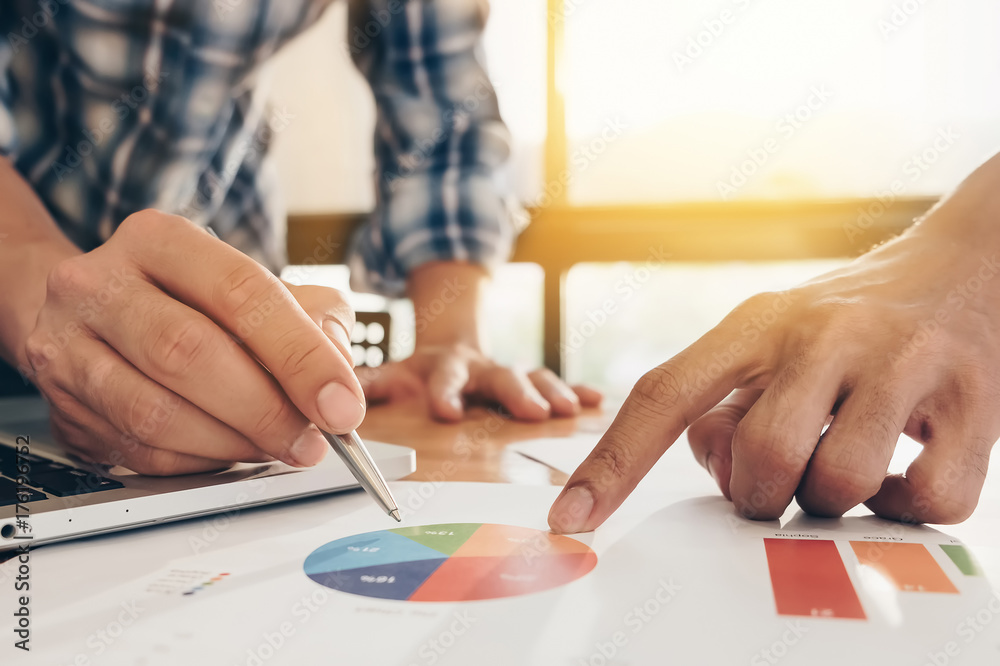 Young business people and partners are analyzing sales figures this year to improve sales next year. Young business people and partners are analyzing sales figures this year to improve sales next year.