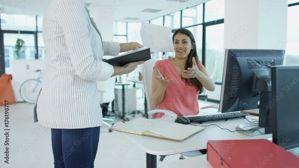 Cheerful casual business group working at their desks in modern office Cheerful casual business group working at their desks in modern office
