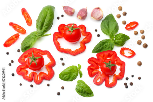 Fototapeta Naklejka Na Ścianę i Meble -  mix of slice of tomato, basil leaf, garlic, sweet bell pepper and spices isolated on white background. top view