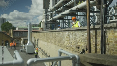 Wallpaper Mural  Team of engineers working together at city construction site Torontodigital.ca