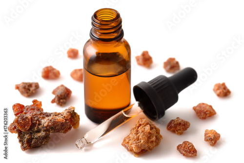 Photo Myrrh essential oil in the amber bottle isolated on white
