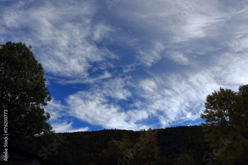 clouds in the sky with shadows of trees in the French Pyrenees. Occitanie in south of France