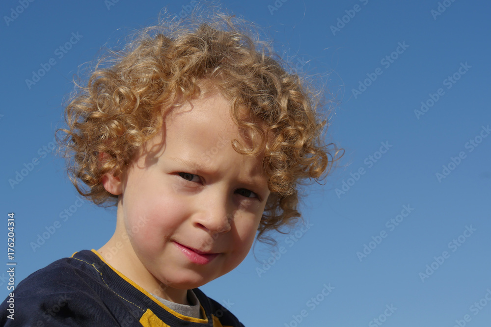 Portrait of little boy with blond and curly hair Portrait of little boy with blond and curly hair