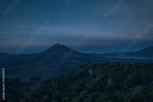 Silhouette of the mountain volcano Batur on background night sky with stars