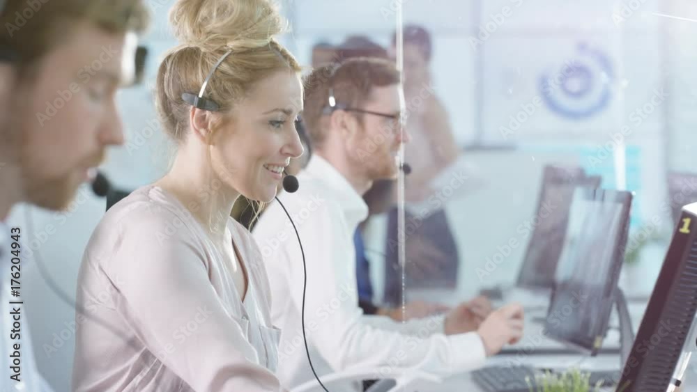  Friendly customer service operators taking calls in busy call center