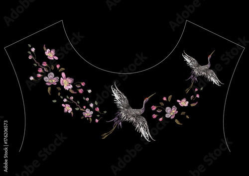 Embroidery oriental neckline pattern with cranes and cherry blossom. Vector embroidered floral patch with bird for clothing design.