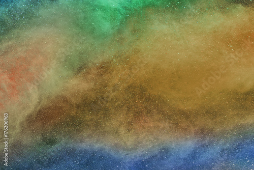 Abstract multicolored powder is spread full in area, horizontal view.