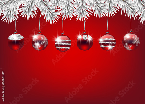 Fir branches decorated with Christmas baubles on white background with space for text.