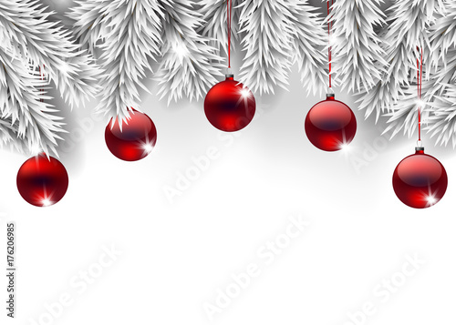 Fir branches decorated with Christmas baubles on white background with space for text.
