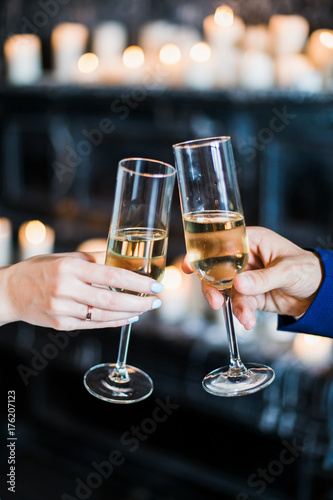 bride and groom holding glasses with champaign