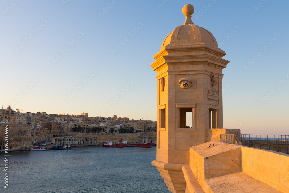The beautiful limestone ancient traditional watch tower at Gardjola Gardens, Il-gardjola in Maltese, overlooking the Grand Harbour and Valletta, Senglea, Malta, June 2017