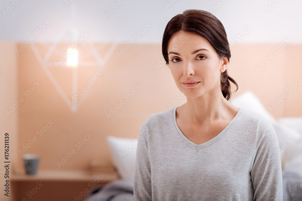 Pleasant woman being in her comfortable bedroom