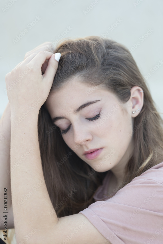 Close-up portrait of a teenage woman with closed eyes. Close-up portrait of a teenage woman with closed eyes.
