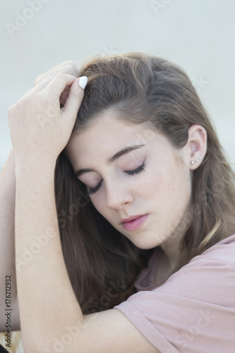 Close-up portrait of a teenage woman with closed eyes.