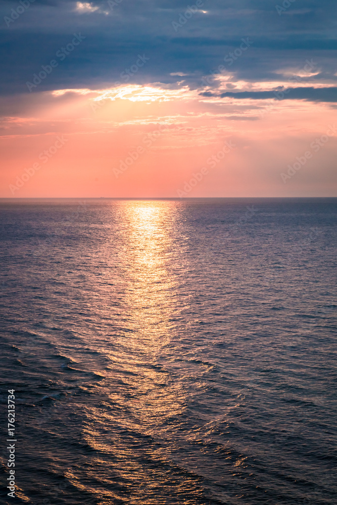 Dynamic dusk over calm ocean in summer