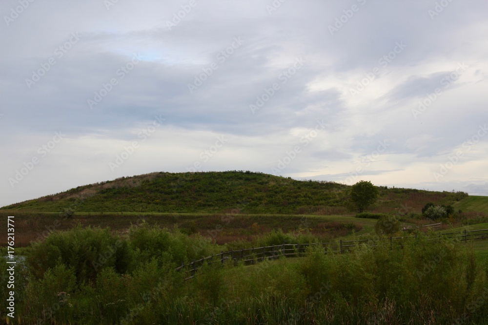 The overcast clouds over the top of the grass hill landscape. The overcast clouds over the top of the grass hill landscape.