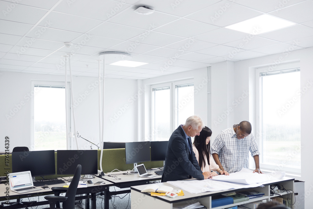 Architects and project managers working in office Architects and project managers working in office