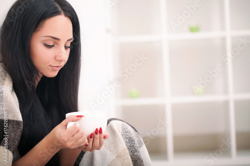 Woman's hand holding a cup of coffee. With a beautiful winter manicure. Drink, fashion, morning