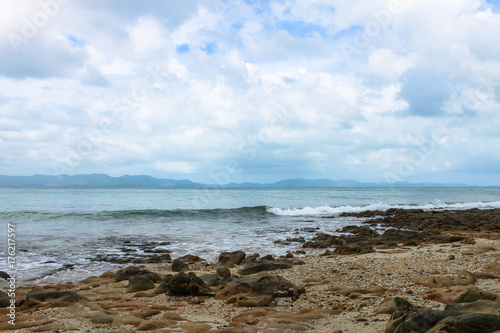 Stony beach  sea and mountains in the distance