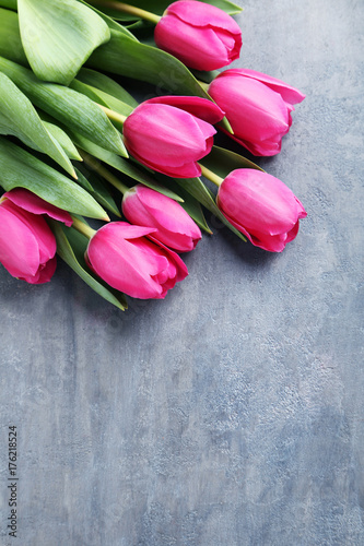 Fototapeta Naklejka Na Ścianę i Meble -  Bouquet of pink tulips on grey wooden table