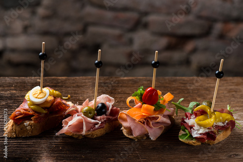 Tapas on Crusty Bread - Selection of Spanish tapas served on a sliced baguette.