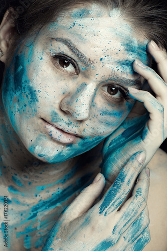 Beautiful model with creative makeup art. Caucasian girl with painted face in blue white flowers photo