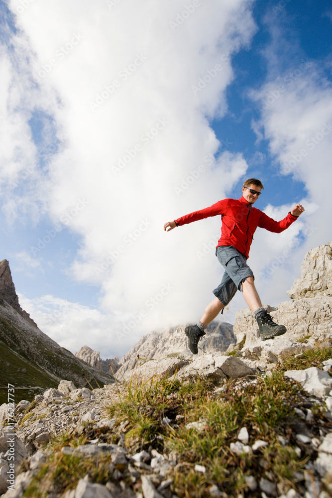 Man jumping from rock to rock