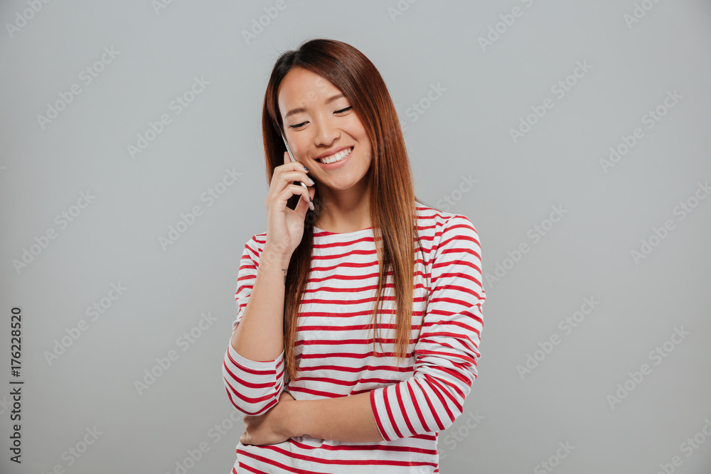 Portrait of a happy asian girl talking on mobile phone Portrait of a happy asian girl talking on mobile phone