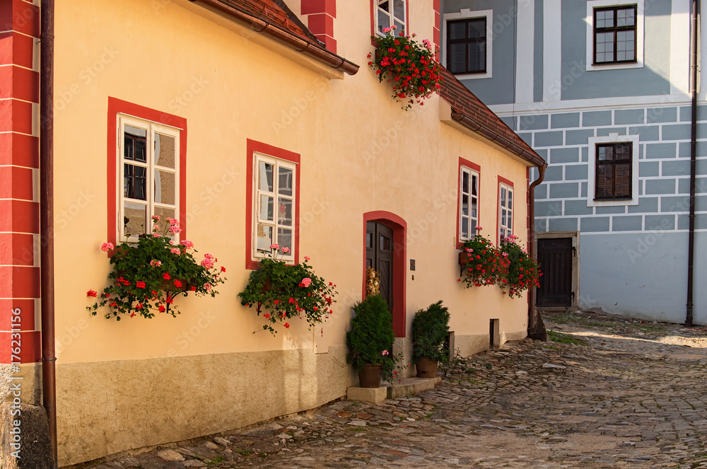 Beautiful view of scenic narrow alley with historic traditional houses and cobbled street in Cesky Krumlov in summer
