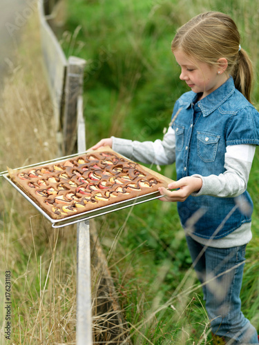 Girl holding tray of applecake © Image Source RF