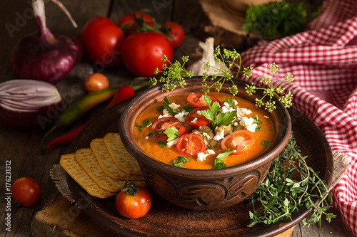 Cream puree soup from baked tomatoes, eggplants, pepper, red onion. Healthy vegetarian food. photo