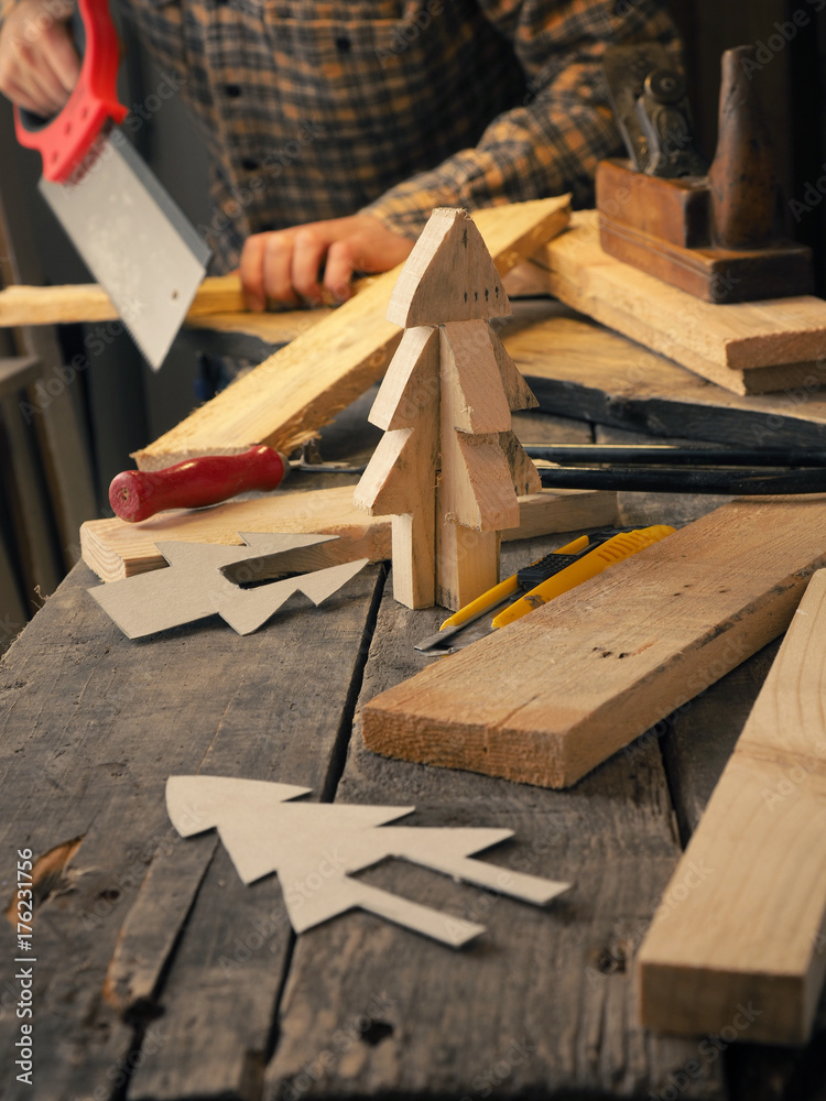 Joiner making a wooden Christmas decoration Joiner making a wooden Christmas decoration