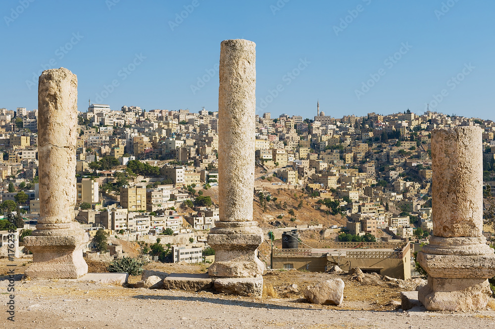 Ancient stone columns at the Citadel of Amman with the blue sky at the background in Amman, Jordan.
